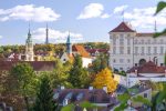 Prague City View with Historic Spire and Autumn Foliage